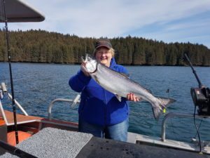 Darlene on boat with salmon